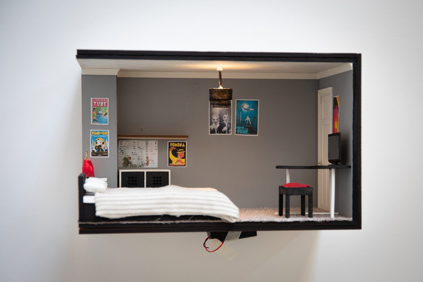 Grey bedroom miniature model with posters